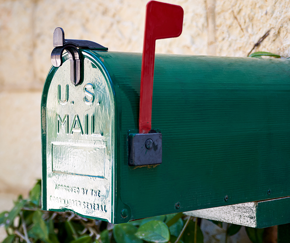 Green US Mail box with red flag up