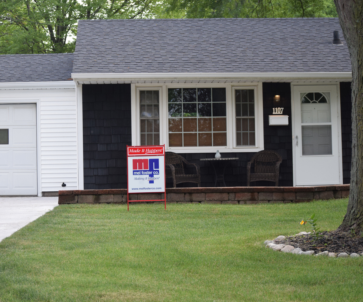 Exterior home front with for sale sign in front